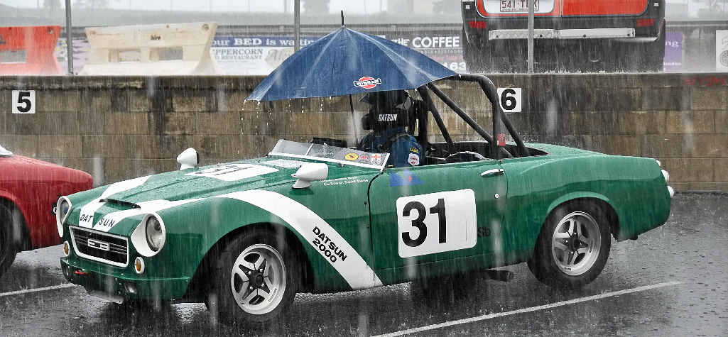 An unfortunate driver had to wait out the rain in his Datsun. An unfortunate driver had to wait out the rain in his Datsun.